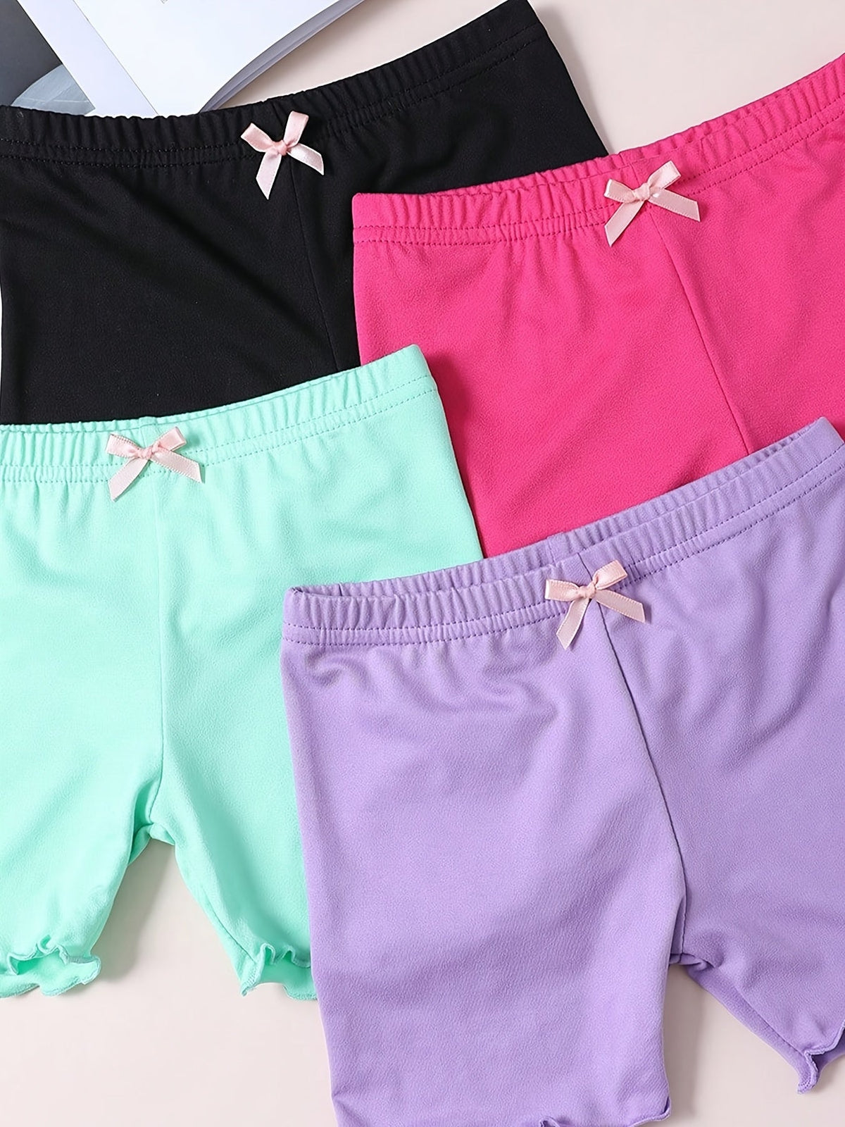 Girls' Layering Shorts Four-Pack with Small Waist Bows and Lettuce Hems for Everyday Dresses and Skirts